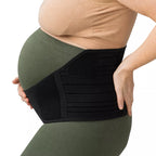 A pregnant woman wearing a 3-in-1 black maternity support band to relieve back and pelvis pressure on a white background.