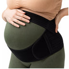 Mom-to-be wearing a black pregnancy support belt on a white background.