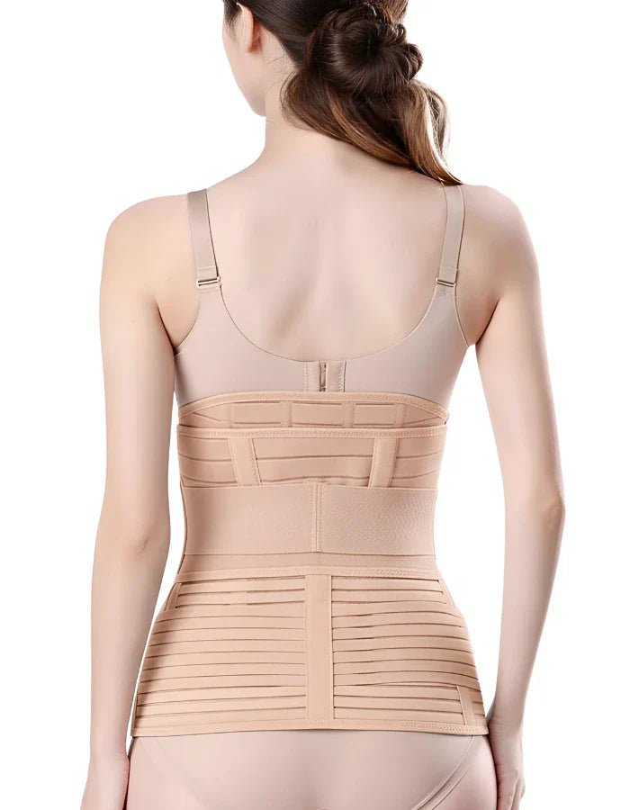 Back view of a woman wearing a beige postpartum recovery belly wrap and a tummy support belt after childbirth.
