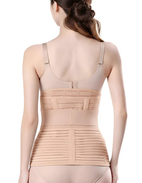 Back view of a woman wearing a beige postpartum recovery belly wrap and a tummy support belt after childbirth.