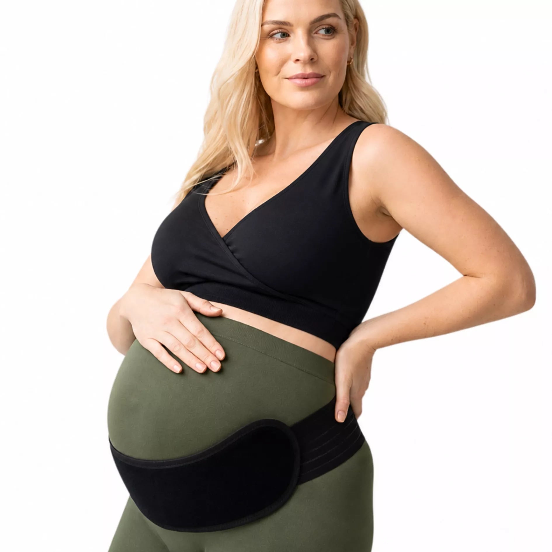 An expectant mother wearing an adjustable black abdominal support pad on a white background. 