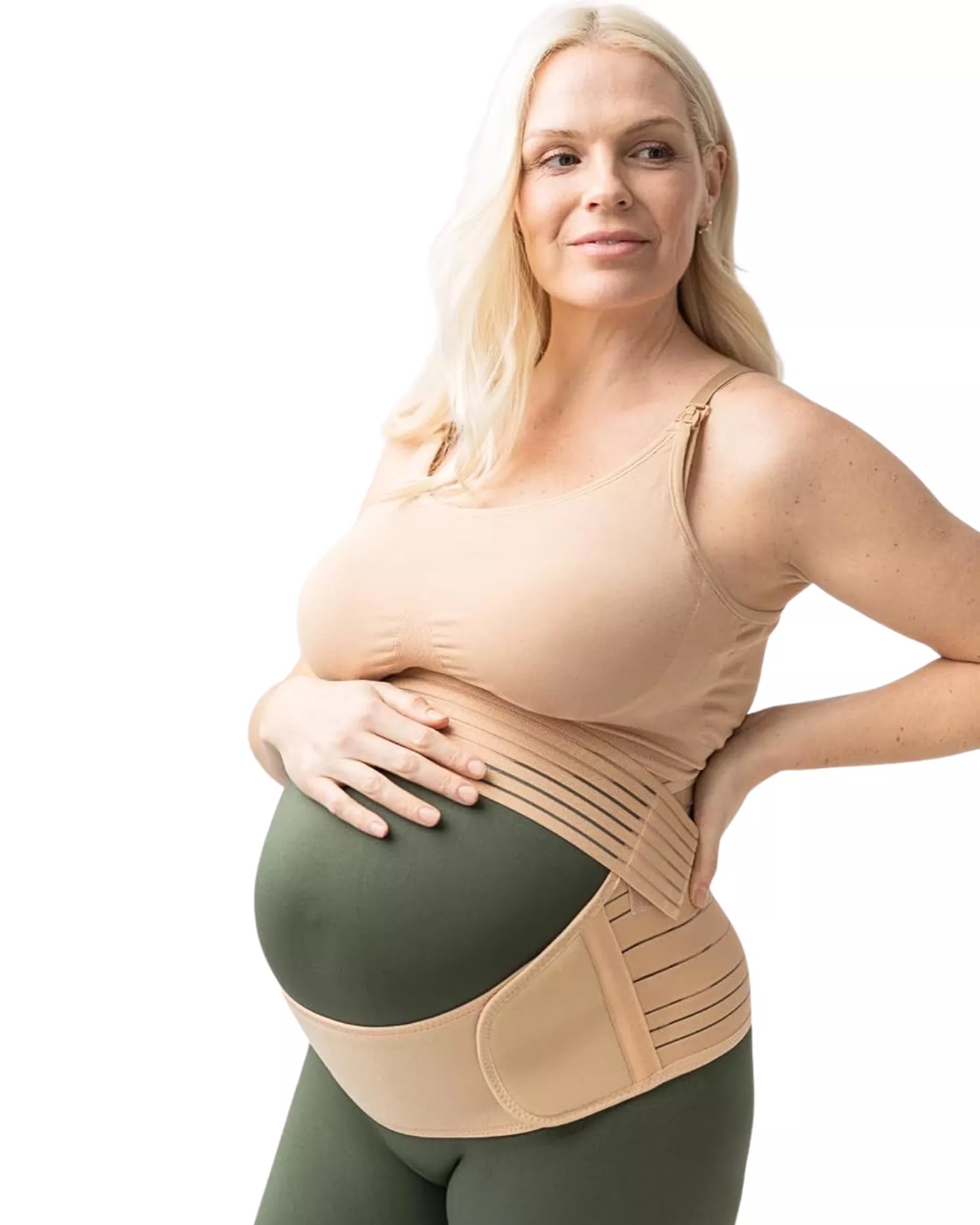 A woman wearing a beige maternity support belt on a white background.